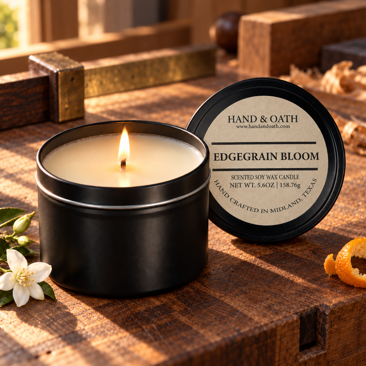 Edgegrain Bloom soy candle in a black tin, styled in a home setting