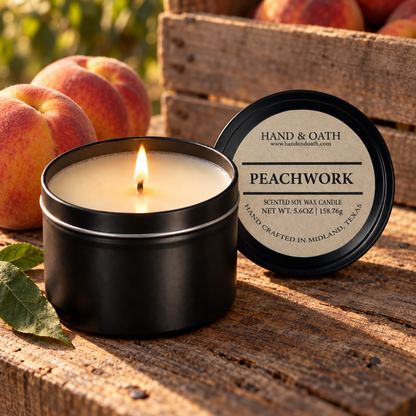 Peachwork soy candle in a black tin, styled in a home setting