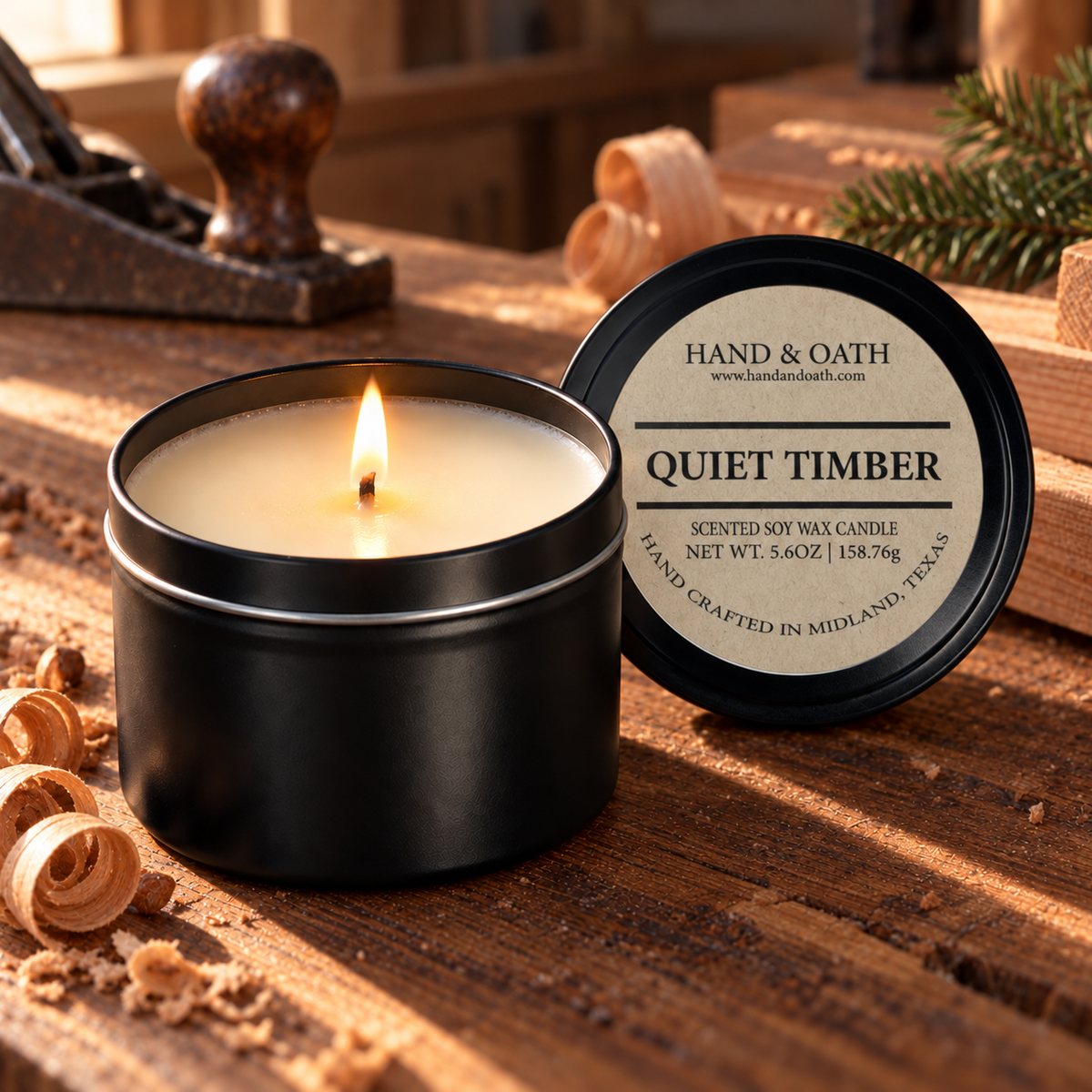 Quiet Timber soy candle in a black tin, styled in a home setting