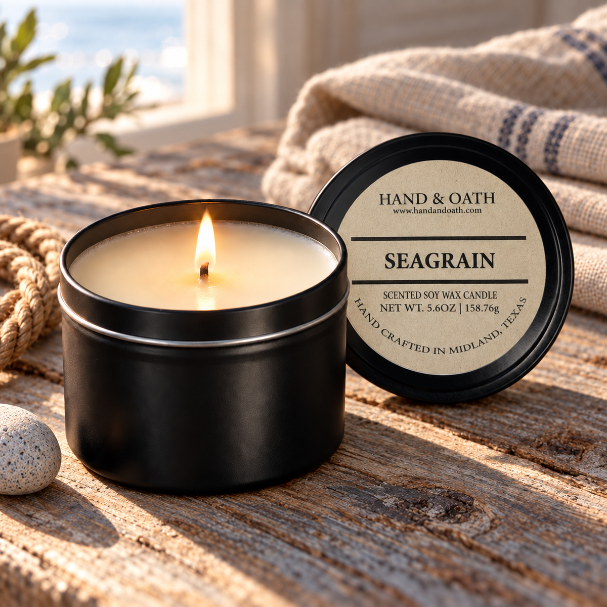 Seagrain soy candle in a black tin, styled in a home setting